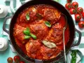 Pollo in umido succulento in padella con pomodoro e basilico, pronto per essere gustato.