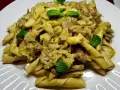 Pasta con carciofi cremosa, guarnita con foglie di menta fresca. Un piatto saporito e invitante.
