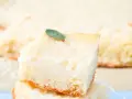 Una fetta di torta di riso carrarina, soffice e profumata, guarnita con una fogliolina verde.