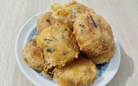 Un piatto di frittelle di zucchine dorate e croccanti, perfette per uno spuntino gustoso.