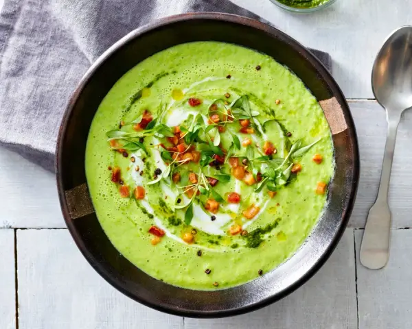 Crema di avocado vellutata, guarnita con cubetti croccanti, erbe fresche e un filo d'olio. Un piatto invitante e salutare.
