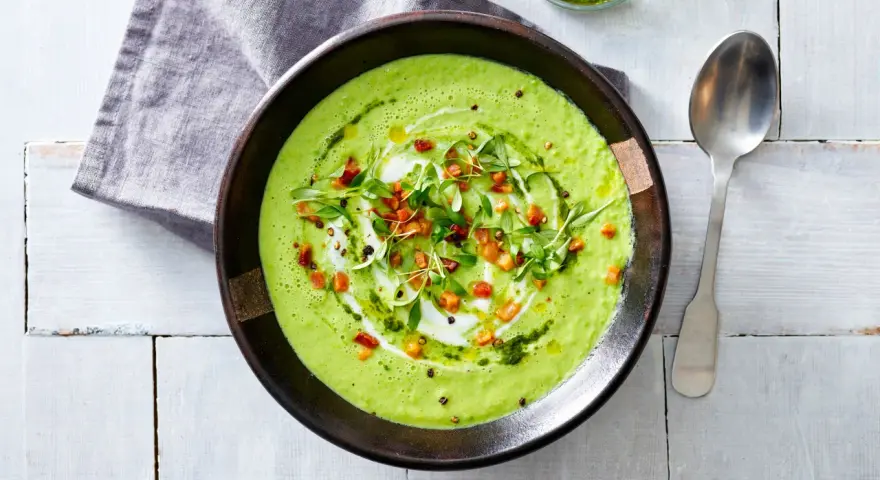 Crema di avocado vellutata, guarnita con cubetti croccanti, erbe fresche e un filo d'olio. Un piatto invitante e salutare.