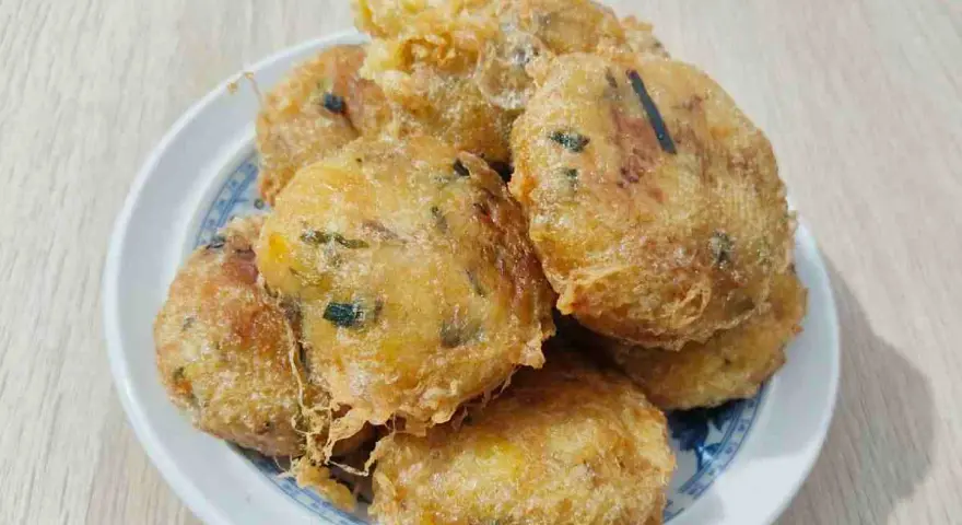 Un piatto di frittelle di zucchine dorate e croccanti, perfette per uno spuntino gustoso.