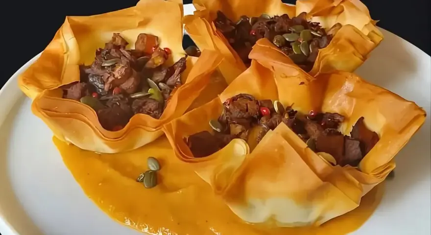 Deliziose coppette croccanti di pasta fillo, ripiene di un gustoso ragù e semi di zucca. Perfette per le tue ricette con pasta fillo.